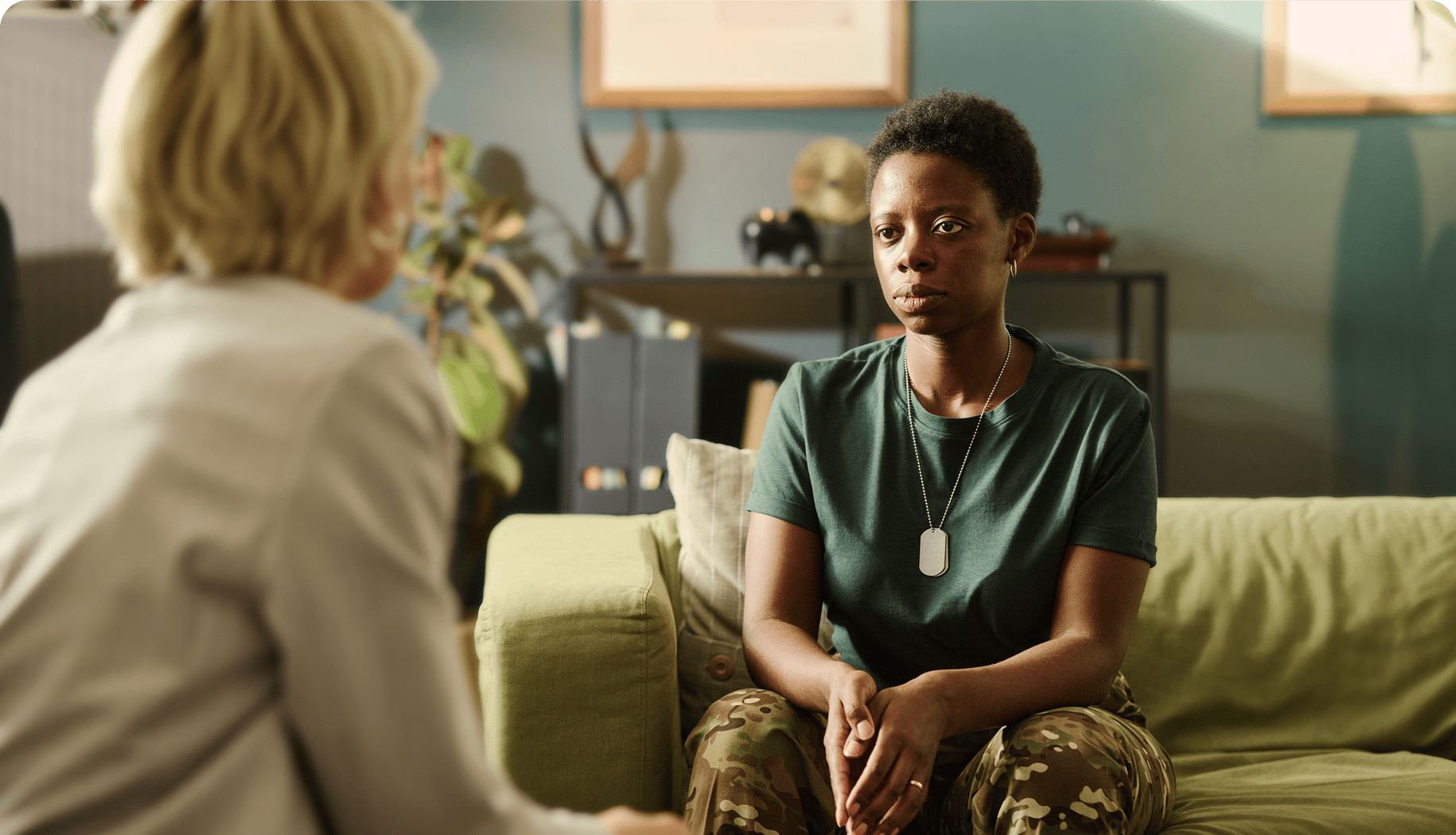 Woman sitting on a couch talking to a man